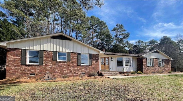 single story home with board and batten siding, crawl space, and brick siding