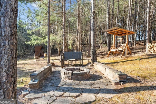 view of yard with a fire pit