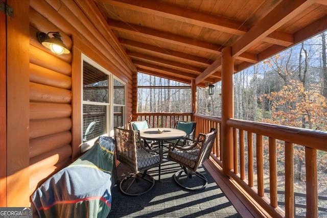 sunroom / solarium with vaulted ceiling with beams and wood ceiling