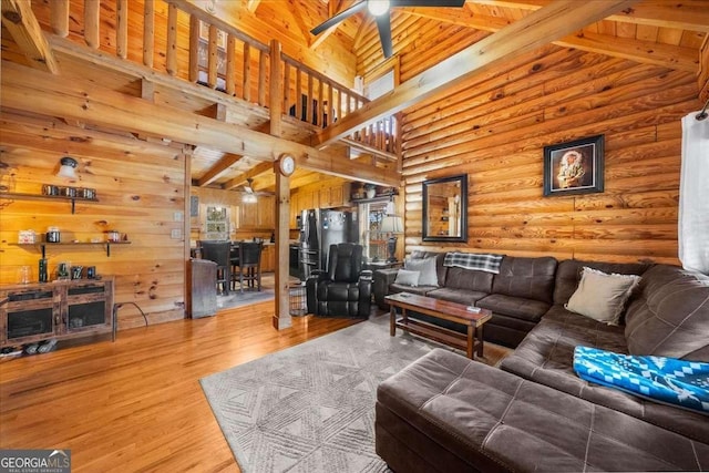 living room featuring high vaulted ceiling, ceiling fan, and wood finished floors