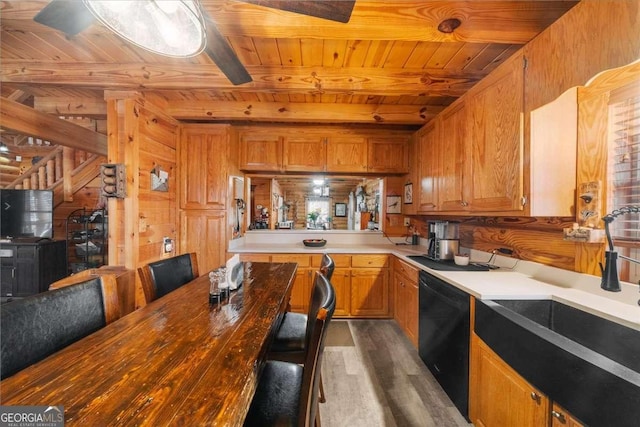 kitchen featuring black dishwasher, brown cabinets, a sink, and wooden ceiling