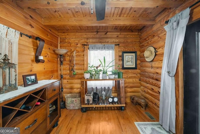 wine cellar featuring beam ceiling, visible vents, wooden ceiling, and light wood-style flooring