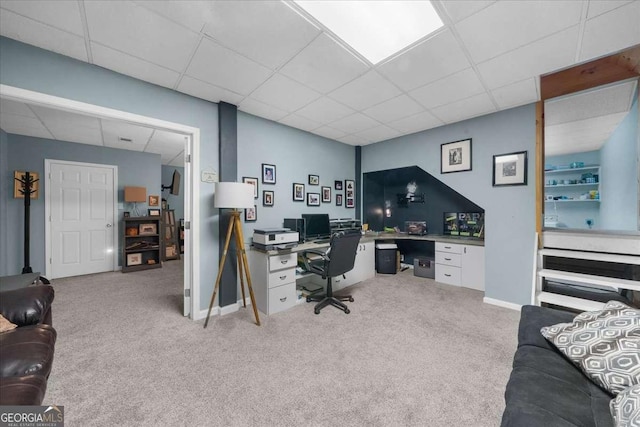 home office with carpet floors, a drop ceiling, and baseboards