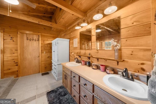 full bathroom featuring double vanity, wood walls, wood ceiling, and a sink