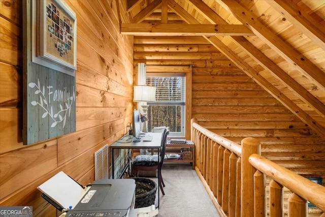 interior space with wooden walls, vaulted ceiling with beams, and log walls