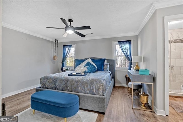 bedroom with multiple windows, wood finished floors, and baseboards