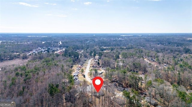 birds eye view of property with a wooded view