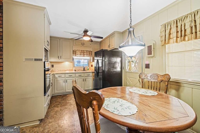 dining space featuring a ceiling fan and tile patterned floors