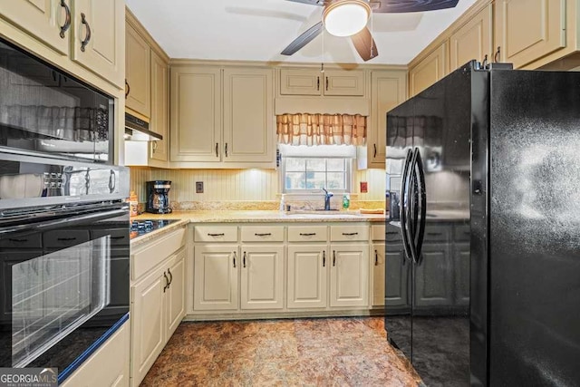 kitchen featuring under cabinet range hood, a sink, a ceiling fan, light countertops, and black appliances