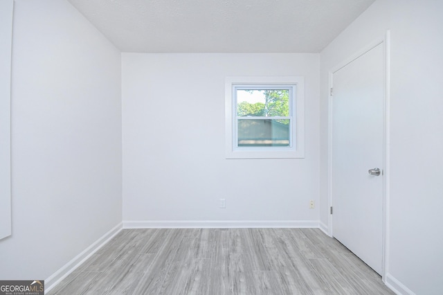 interior space with baseboards and light wood finished floors