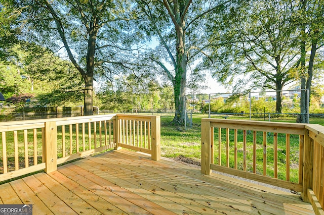 deck with a fenced backyard and a yard