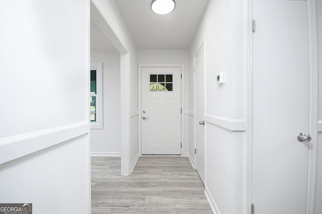 entryway featuring light wood finished floors and baseboards