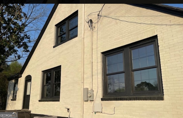 view of home's exterior with brick siding