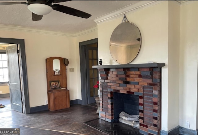 living room featuring dark wood-style floors, ornamental molding, a brick fireplace, ceiling fan, and baseboards