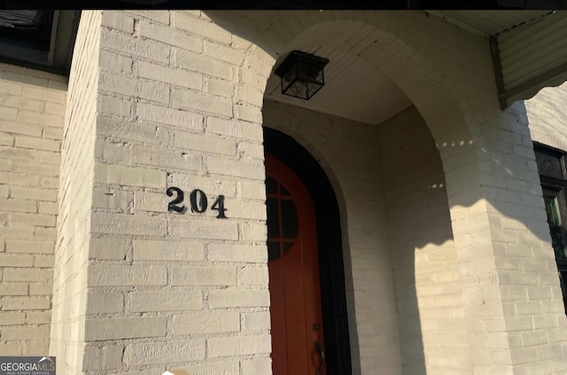 exterior details featuring arched walkways and brick siding