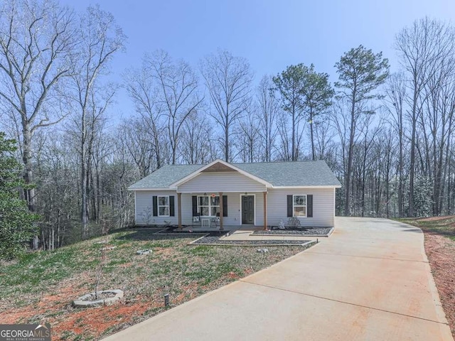 view of front of property featuring a porch and a shingled roof