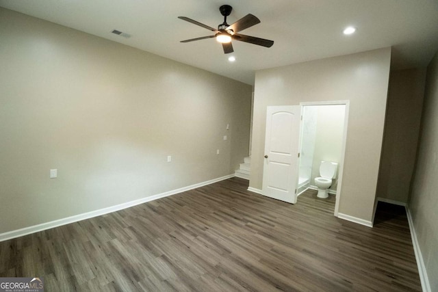 unfurnished bedroom with dark wood-style flooring, recessed lighting, visible vents, ensuite bath, and baseboards