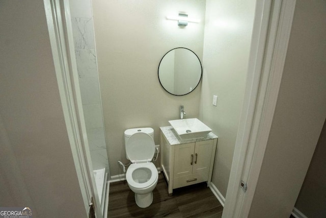 full bathroom featuring baseboards, vanity, toilet, and wood finished floors