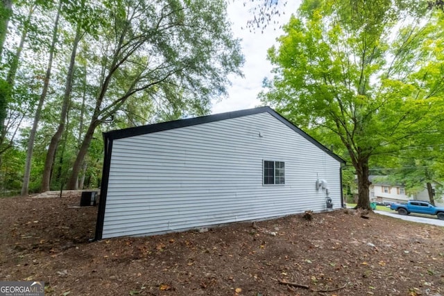 view of side of property with central air condition unit