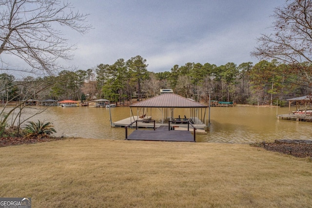 view of dock with a water view and a yard