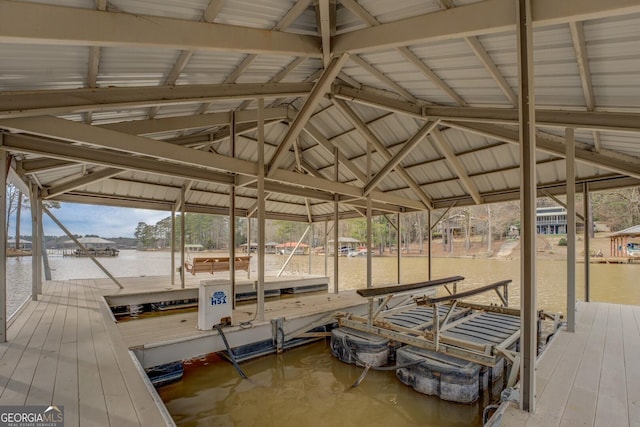 dock area with a water view and boat lift