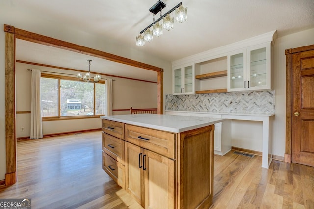 kitchen featuring white cabinets, light wood-style flooring, open shelves, and light countertops