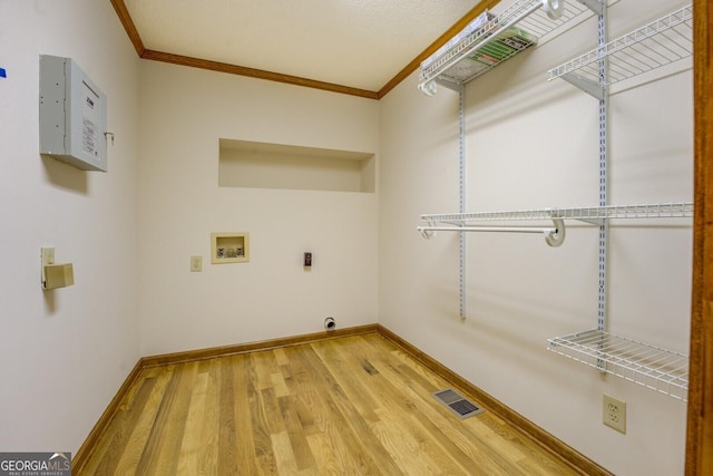 laundry area with hookup for a washing machine, laundry area, wood finished floors, visible vents, and ornamental molding