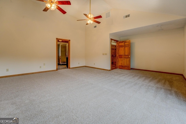 empty room with carpet floors, visible vents, high vaulted ceiling, and baseboards