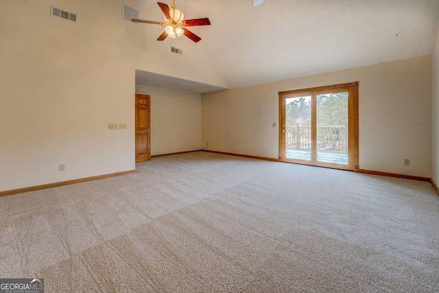 spare room featuring high vaulted ceiling, visible vents, light carpet, and baseboards