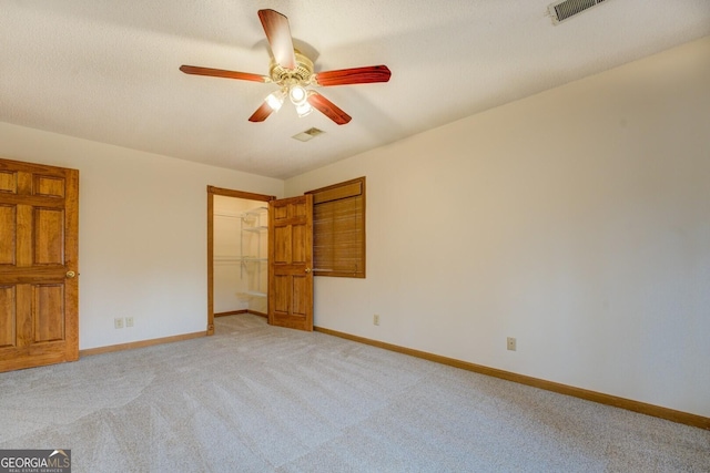 unfurnished bedroom featuring visible vents, light carpet, and baseboards