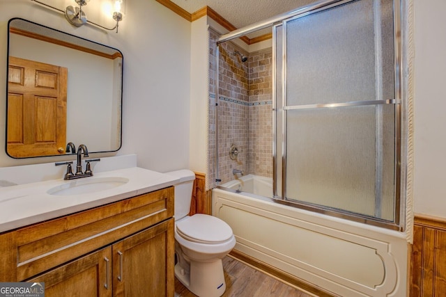 full bath with a textured ceiling, toilet, wood finished floors, vanity, and ornamental molding