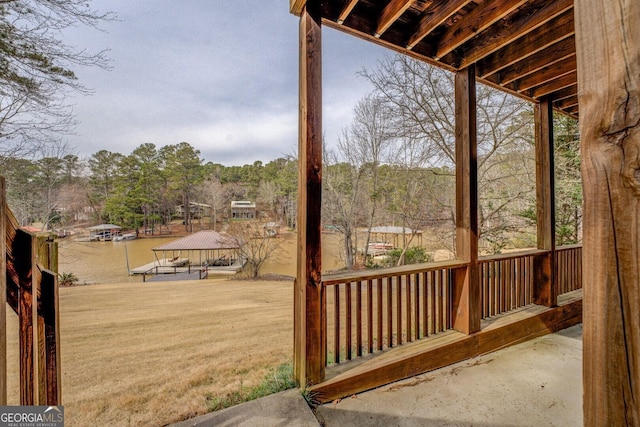 wooden terrace featuring a view of trees and a gazebo