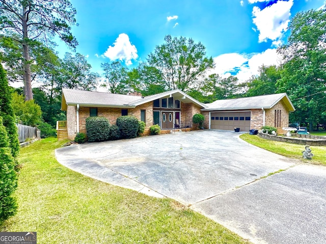 view of front of house with a garage, a chimney, a front lawn, and brick siding