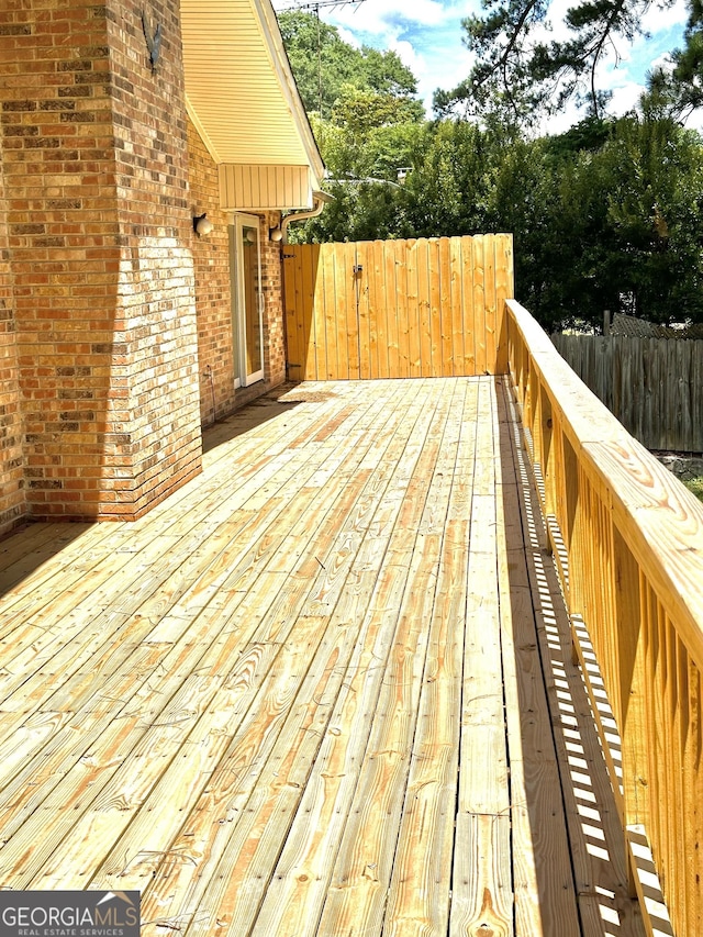 wooden terrace featuring fence