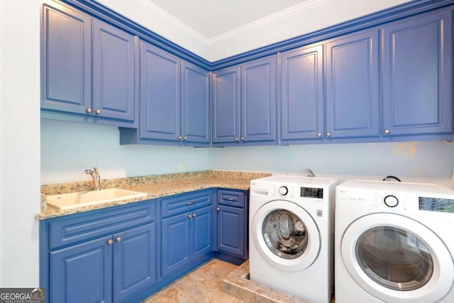 washroom with crown molding, cabinet space, a sink, and washing machine and clothes dryer