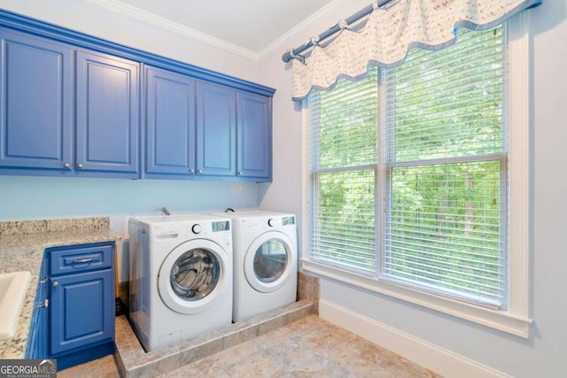 clothes washing area featuring cabinet space, baseboards, washer and clothes dryer, crown molding, and a sink