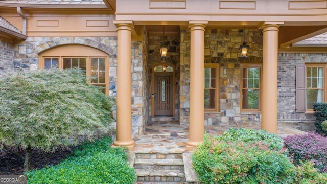 property entrance featuring stone siding