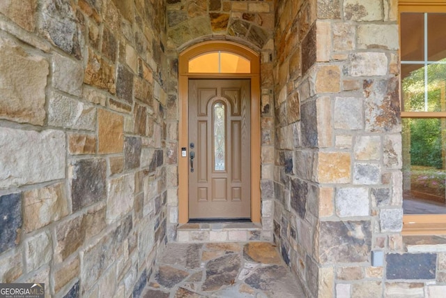 property entrance with stone siding