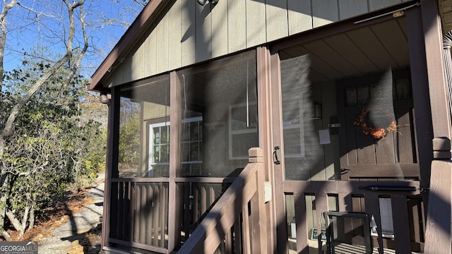 view of home's exterior with a sunroom and board and batten siding