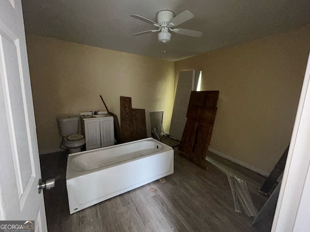 bedroom featuring ceiling fan, wood finished floors, and baseboards