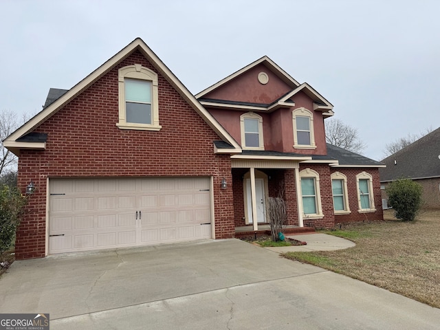 traditional home featuring an attached garage, a front lawn, concrete driveway, and brick siding