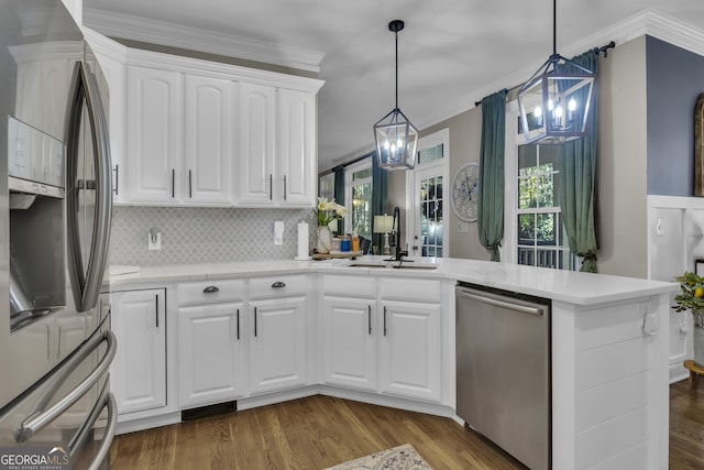 kitchen with dark wood-style flooring, appliances with stainless steel finishes, crown molding, and a sink