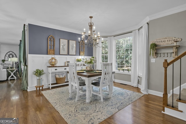 dining area featuring crown molding, stairway, wood finished floors, and visible vents