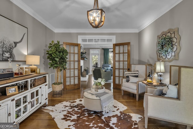 living area with french doors, crown molding, and dark wood-style flooring