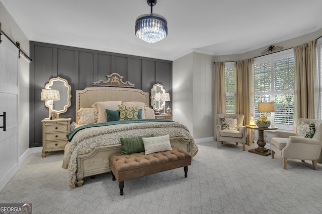 bedroom with a barn door, carpet, an inviting chandelier, and crown molding