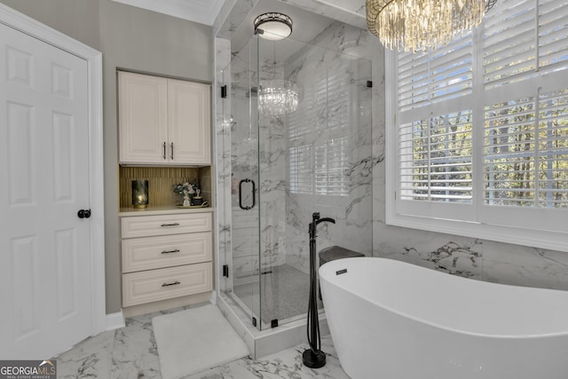 full bath featuring a marble finish shower, a soaking tub, marble finish floor, and a notable chandelier