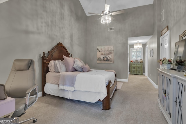 bedroom featuring visible vents, baseboards, light colored carpet, ceiling fan with notable chandelier, and a towering ceiling