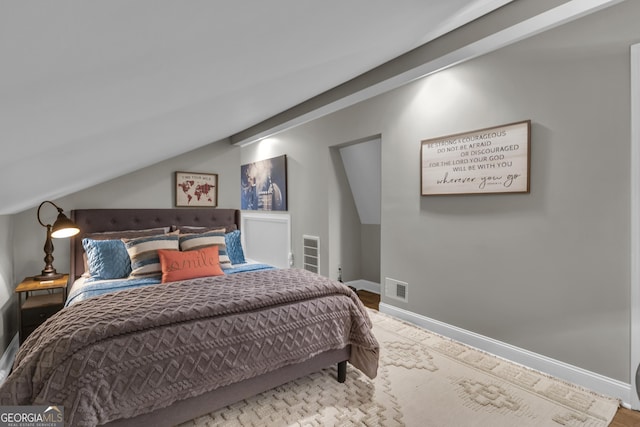 bedroom featuring visible vents, baseboards, and vaulted ceiling