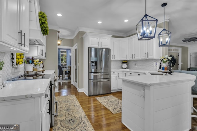 kitchen featuring a sink, stainless steel appliances, white cabinets, and crown molding