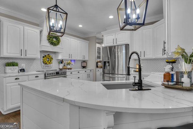 kitchen featuring a sink, ornamental molding, a chandelier, and stainless steel appliances